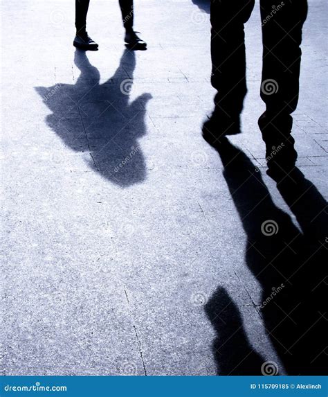 Silhouette Shadows Of Two People Walking Alone In The Night Stock Image