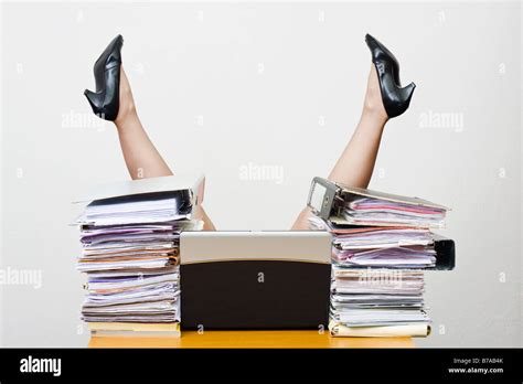 Legs Of An Overworked Businesswoman Sticking Up In The Air Behind A