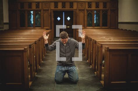 Man Kneeling In Prayer With Hands Raised — Photo — Lightstock
