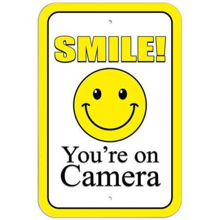 The old ones have been reinstalled and new ones are being. Smile You're on Camera Yellow Sign | Yellow sign, Store ...