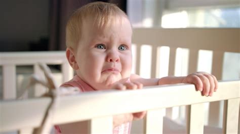 Premium Photo Sad Baby Crying In Cot At Home Unhappy Toddler Standing