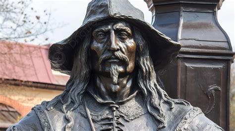 This Statue Of A Man With A Hat And Long Hair Is Standing In Front Of A