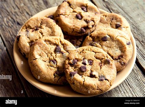 Chocolate Chip Cookies On Plate And Rustic Wooden Table Stock Photo Alamy
