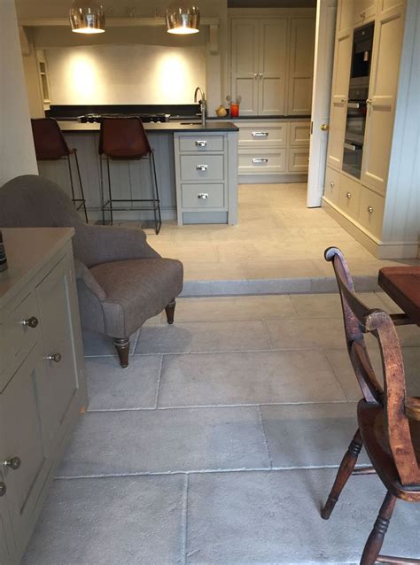 Ceramic tile floors are cost effective. Antiqued grey stone tiles have been used to create this ...