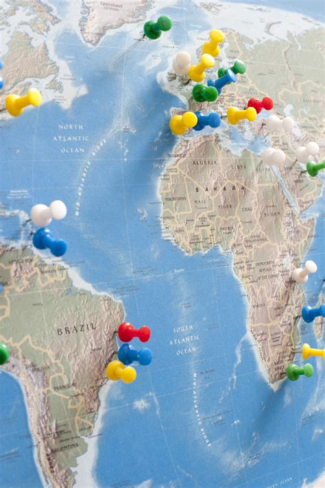 Image Of Tacks Pinned Into Multiple Locations On World Map Freebie