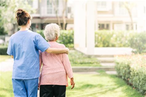 Premium Photo Nurse Caregiver Support Walking With Elderly Woman Outdoor