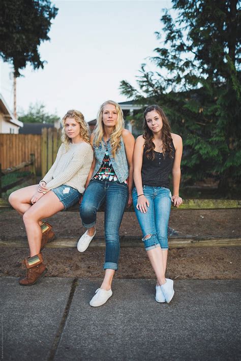 Group Of Real Teenage Girls Posing For Serious Portrait Together Outside By Stocksy