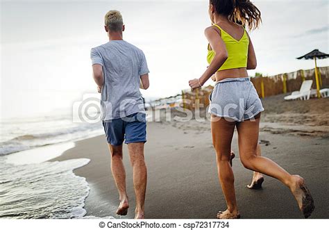 Group Of Sport People Running On The Beach Group Of Sport People