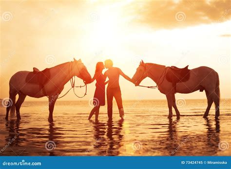 In Love Couple Kissing On The Beach Two Horses At Sunset Summer Scene