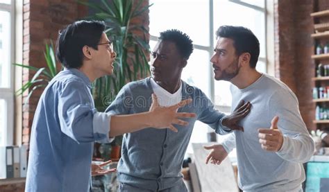 Multiracial Coworkers Having Quarrel In Office Conflict Of Interest