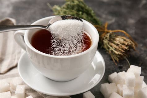 Adding Of Sugar To Cup With Aromatic Tea On Grey Table Stock Image Image Of Addiction Organic