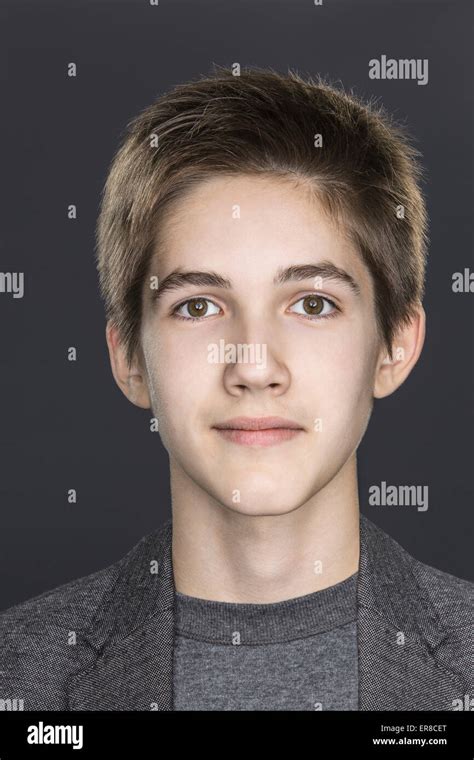 Close Up Portrait Of Confident Teenage Boy Over Gray Background Stock