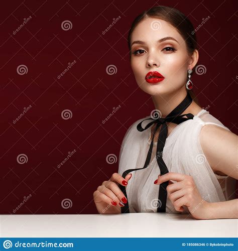 Beautiful Girl In White Dress With Classic Make Up And Red Manicure