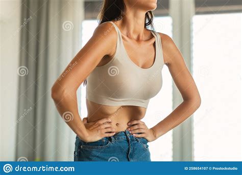 Unrecognizable Lady Doing Stomach Vacuum Exercise Standing At Home