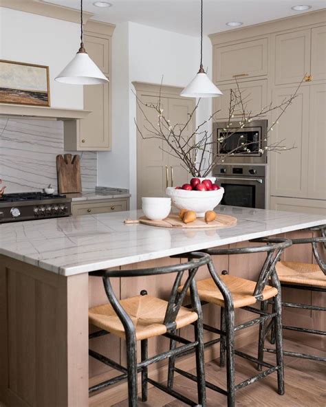 Neutral Kitchen With Tree Branch Centerpiece And Wishbone Counter