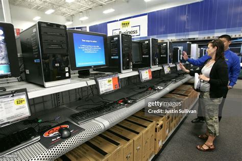 A Best Buy Customer Looks At A Display Of Hp Desktop Computers At A