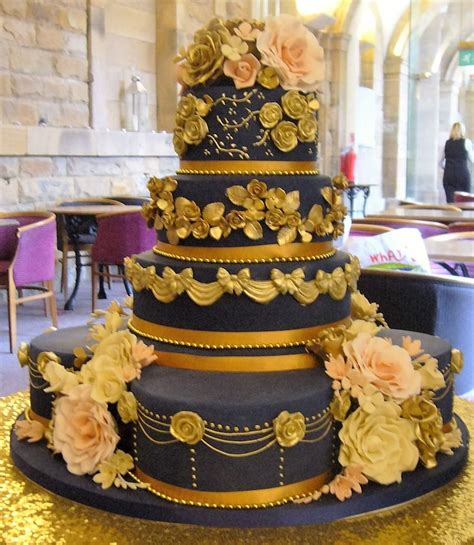 Seven Tier Wedding Cake In Navy Blue With Gold Accents And Blush