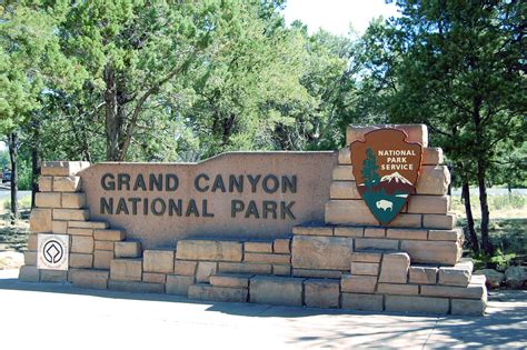 A camera pole is attached to the ground so the whole group can get into the photo. Grand Canyon National Park: South Entrance Sign 0102 World ...