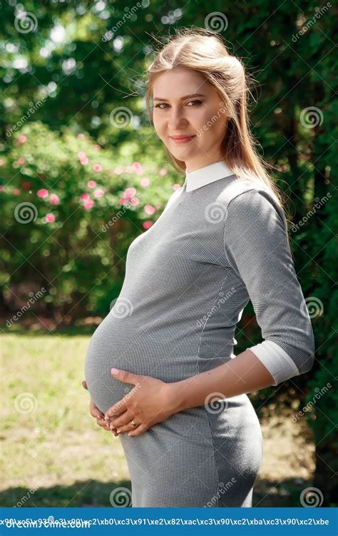 Beautiful Pregnant Girl In A Park On A Green Background Tenderness