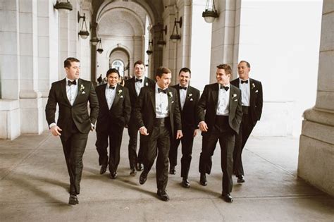 A Group Of Men In Tuxedos Are Walking Together