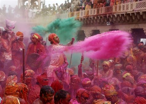 People Throw Coloured Powder As They Celebrate Lathmar Holi At