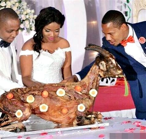 Hilarious Photo Of Newly Wedded Couple Cutting Roasted Goat Instead Of