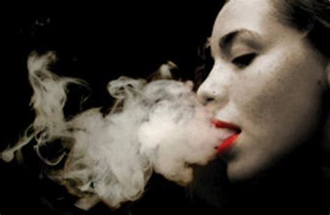 Girl Blowing Out Smoke