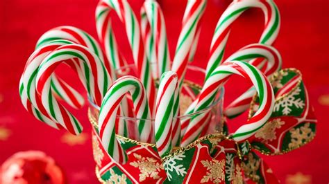 Candy Canes Inside Water Glass In Red Background Hd Candy Cane