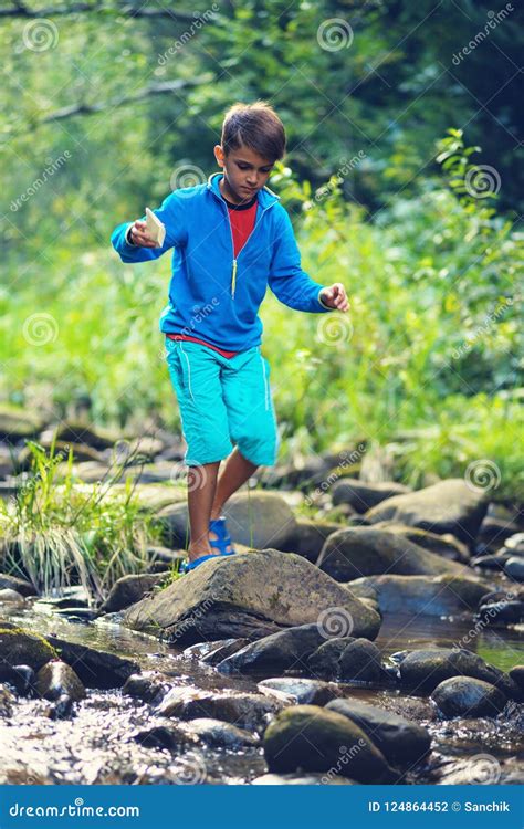 Small Boy Walks The Rocks Across The Mountain River Stock Photo Image