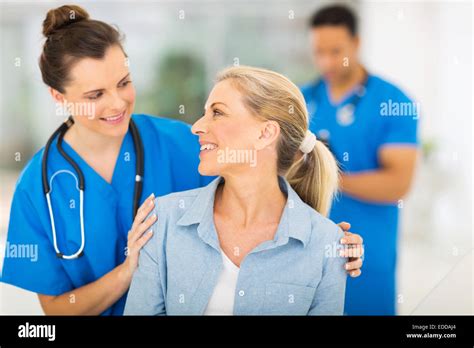 Caring Nurse Talking To Senior Woman In Hospital Stock Photo Alamy