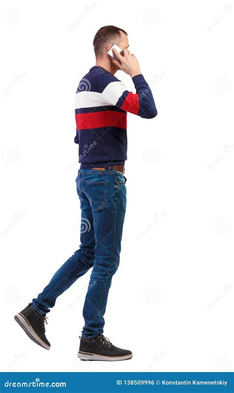 A Side View Of Man Walking With A Mobile Phone Stock Photo Image Of