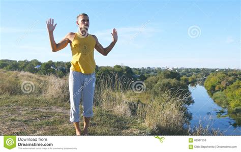 Guy Practicing Yoga Moves And Positions Outdoors Young Man Standing At