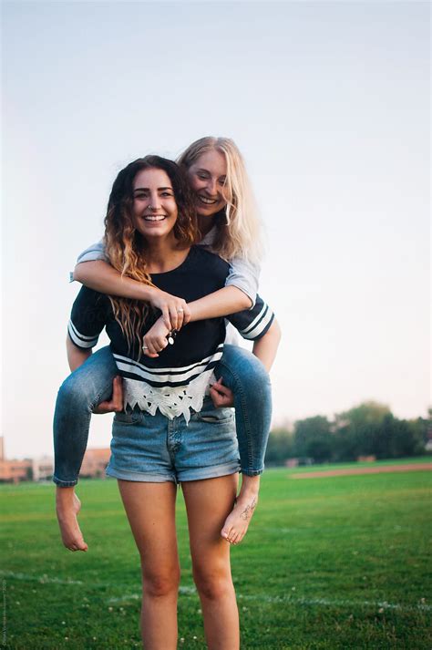 Sisters On A Piggyback Ride By Stocksy Contributor Chelsea Victoria
