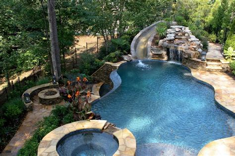 We bought the house with the pool in it so we had not spent money in building the pool but we do have to do the swimming pool maintenance services once every year. pool with slide waterfall grotto cave | Pool waterfall, Pool landscaping, Grotto pool