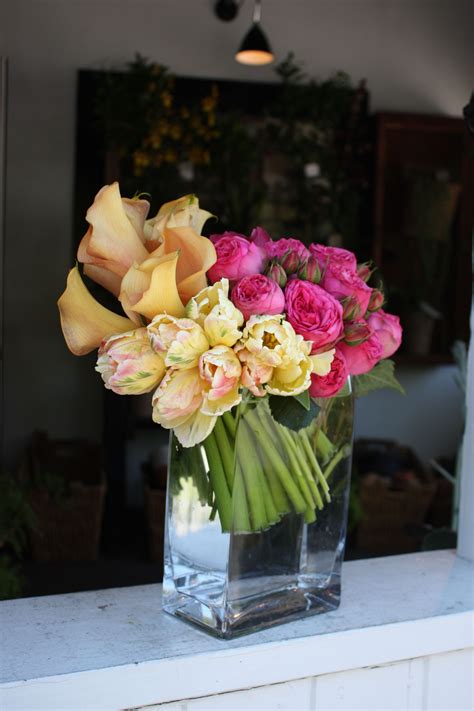A Modern Mix Of Peach Calla Lillies Yellow Parrot Tulips And Pink