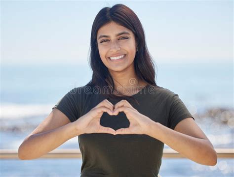 beach portrait and heart hand woman for summer holiday freedom happiness and wellness happy