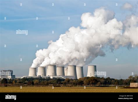 Cooling Towers Of A Power Plant With Steam Clouds And Sky Stock Photo