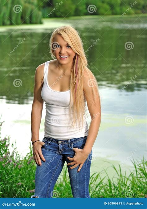 Young Blonde Woman In White Tank Top And Jeans Stock Image Image Of
