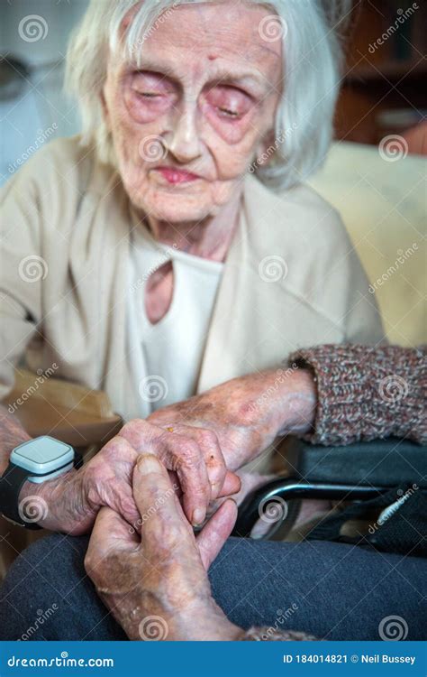 Elderly Womanle With Alzheimer S And Dementia Holding Her Husbands Hand