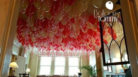 Balloons are often hung from the ceiling at wedding receptions. Balloon ceiling fills can brighten up any heart on ...