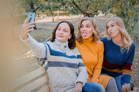 Cheerful Attractive Three Young Women Best Friends Having Fun And Make Selfie Together Outside