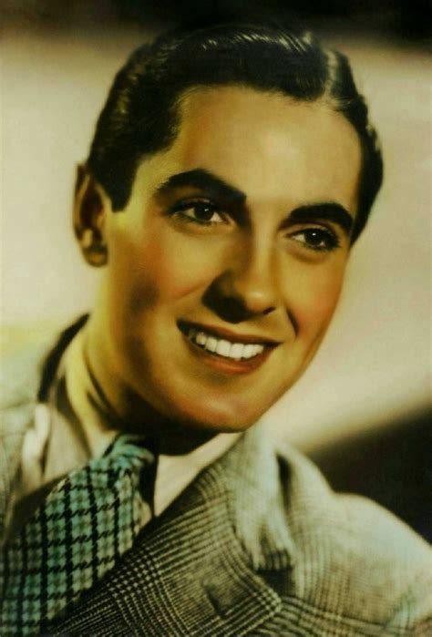 an old photo of a man wearing a suit and tie smiling at the camera with his eyes wide open