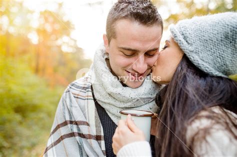Beautiful Young Couple In Love Hugging And Kissing Sunny Autumn Forest
