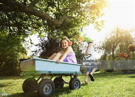 Girl Pulling Girl In Wagon Photo Getty Images