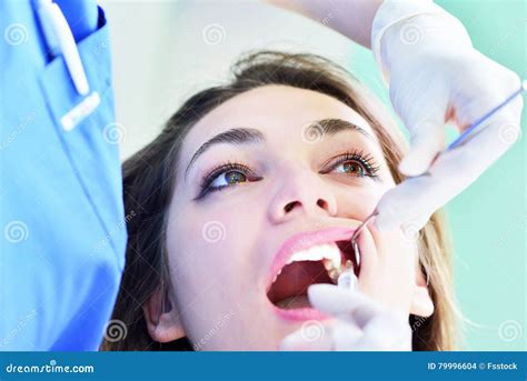 Close Up Of Female With Open Mouth During Oral Checkup At The Dentist
