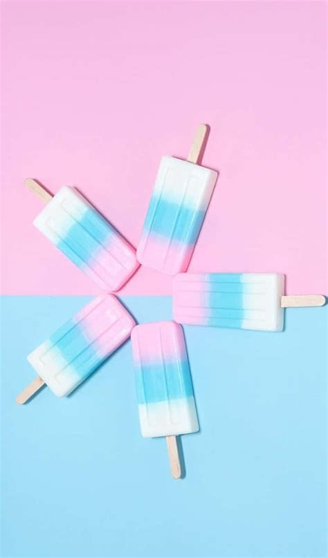 Download A Group Of Popsicles On A Pink And Blue Background Wallpaper