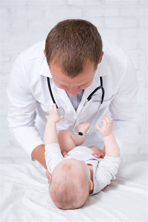 Male Doctor Pediatrician Examining Little Baby Patient Stock Photo
