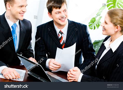 Three People Gathered Together Around The Table And Discuss Ideas At