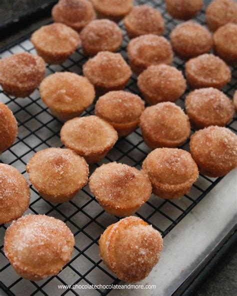 Some Sugared Pastries Are Sitting On A Cooling Rack