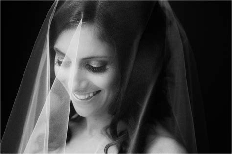 Black And White Wedding Photo Of The Bride Wearing A Veil Over Her Face